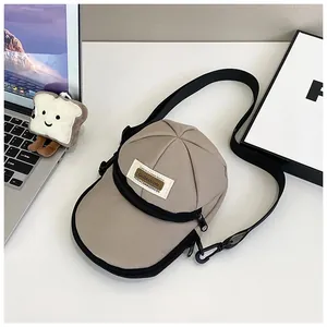 Detailed top view of a khaki baseball cap shaped nylon crossbody bag with zipper