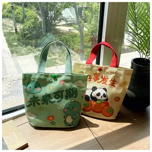 Detail of small cartoon canvas tote bags with snap buttons on a sunny wooden windowsill