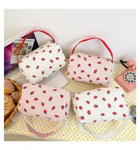 Detail of strawberry corduroy pencil case with clear texture and portable handle
