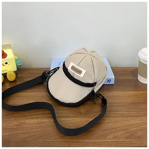 Creative beige baseball cap shaped crossbody bag with black zipper and adjustable strap