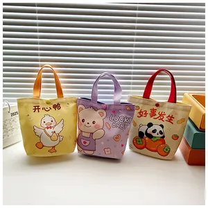 Detail of three cartoon canvas bags with cute duck, bear and panda patterns and snap closure