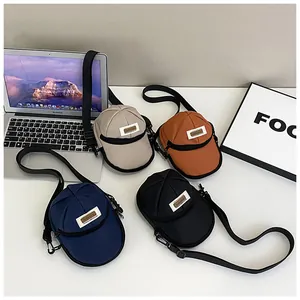 Detail of creative baseball cap shaped nylon cross-body bags in four assorted colors