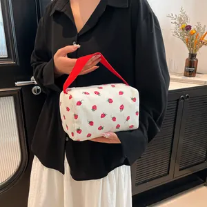 Floral corduroy strawberry makeup bag with red handle for travel and cosmetic storage