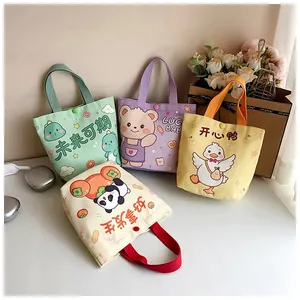 Detail of colorful mini canvas gift bags with cute cartoon prints and snap closure