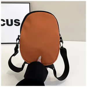 Close-up of vibrant orange nylon crossbody phone bag with black zipper and adjustable strap