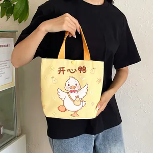 Cute yellow canvas tote bag with a cartoon white duck and button closure for lunch