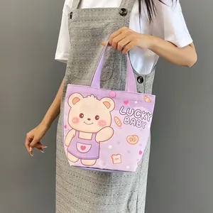 Light purple canvas tote bag with cute cartoon bear and LUCKY BABY print shown by model