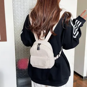 Mini beige corduroy backpack for women featuring adjustable straps and compact design