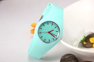 Close-up of Geneva silicone watch in mint green with red hands on a creative background