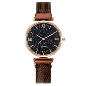 Detail of starry dial quartz watch with roman numerals and magnetic mesh band