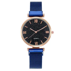 Detail of blue starry watch dial with Roman numerals and magnetic mesh strap
