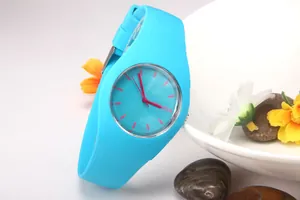 Detail of cyan Geneva silicone watch leaning on a white bowl with decorative flowers