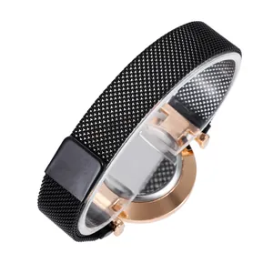 Detail of Milanese stainless steel mesh strap and rose gold case on a watch