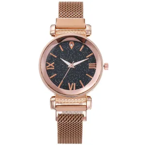 Close-up of rose gold starry sky dial with roman numerals and magnetic mesh strap