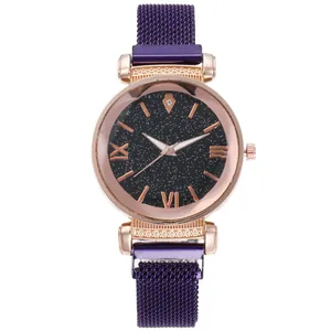 Detailed close-up of purple Milanese mesh strap and rose gold star-themed watch dial