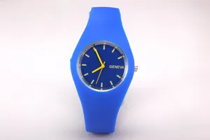 Detail of blue silicone Geneva watch dial with yellow hands and tactile strap