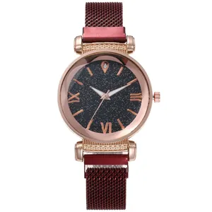 Detail of starry sky watch dial with Roman numerals and red milanese magnetic strap
