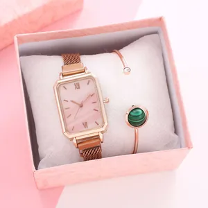 Detail of rose gold square watch and malachite bracelet set in a pink gift box