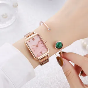 Detail of rose gold rectangular watch with pink dial and matching malachite cuff bracelet