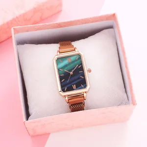 Elegant rose gold rectangular watch with emerald marble dial in a pink gift box
