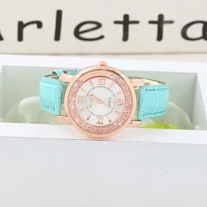 Macro view of light blue leather strap with crocodile texture and rose gold watch case