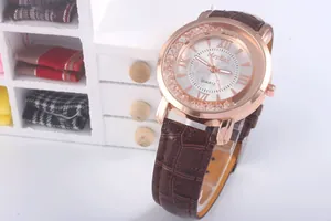 Detail of rose gold ladies watch with Roman numerals, floating crystals and brown leather strap