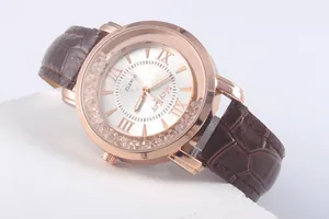 Detailed close-up of rose gold watch dial with Roman numerals and floating crystals