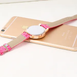 Detail view of the rose gold watch case back with pink crocodile texture leather strap