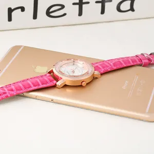 Detailed macro view of rose gold watch case with crystal bezel and Roman numerals