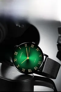 Close-up of Geneva quartz watch featuring a green sunray dial and black mesh band