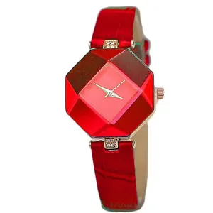 Detail of red geometric faceted dial watch with crystal accents and leather strap