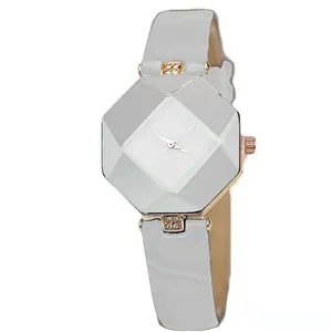 Detail view of octagon-cut diamond glass watch face with rose gold case and gray leather strap
