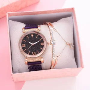 Close-up of women's purple mesh watch and diamond star bracelet in a pink gift box
