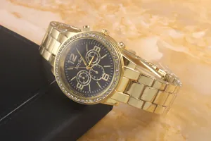 Detail of gold quartz watch featuring a black dial and sparkling rhinestone bezel