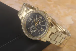 Macro view of gold quartz watch with rhinestone bezel and decorative sub-dials details