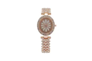 Luxury rose gold women's oval watch with rhinestones and floral dial on white background