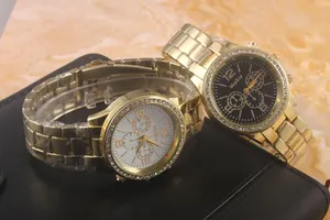 Detail of luxury gold quartz watches with rhinestone bezels and metallic link straps