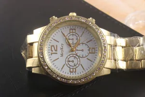 Detail of gold quartz watch featuring a crystal bezel and white multi-dial face