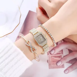 Close-up of gold square watch with crystal bracelet and infinity bangle on woman's wrist