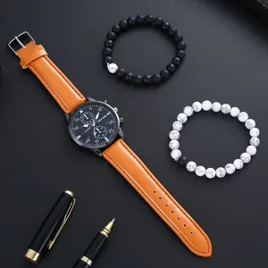Close-up of men's quartz watch with orange leather strap, black dial and bead bracelets