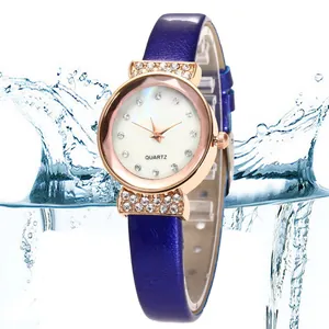 Detail of rose gold watch with purple leather strap and sparkling crystal lugs