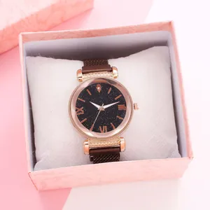 Detail of starry sky dial watch with mesh band and matching pink textured gift box