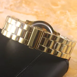 Golden stainless steel quartz watch featuring a triple-link band and folding clasp finish