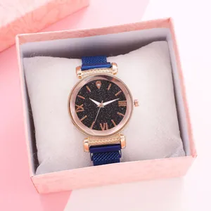 Close-up of starry sky dial watch with blue magnetic band in marble pattern gift box