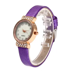 Detail view of purple leather strap and rose gold rhinestone quartz watch for women