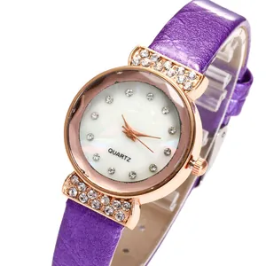 Detail view of purple leather strap watch with rose gold case and rhinestone markers