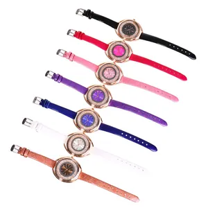 Detail view of seven colorful rhinestone ladies watches with embossed leather straps