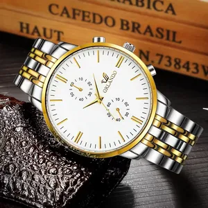 Detail of silver-gold stainless steel watch strap and luxury white dial with golden markers