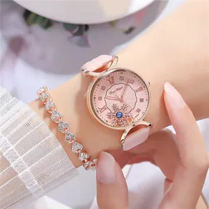 Detail of pink leather watch with rotating snowflake dial and heart-shaped bracelet set