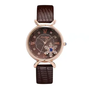 Detail of rose gold watch with brown leather strap and sunburst Roman numeral dial